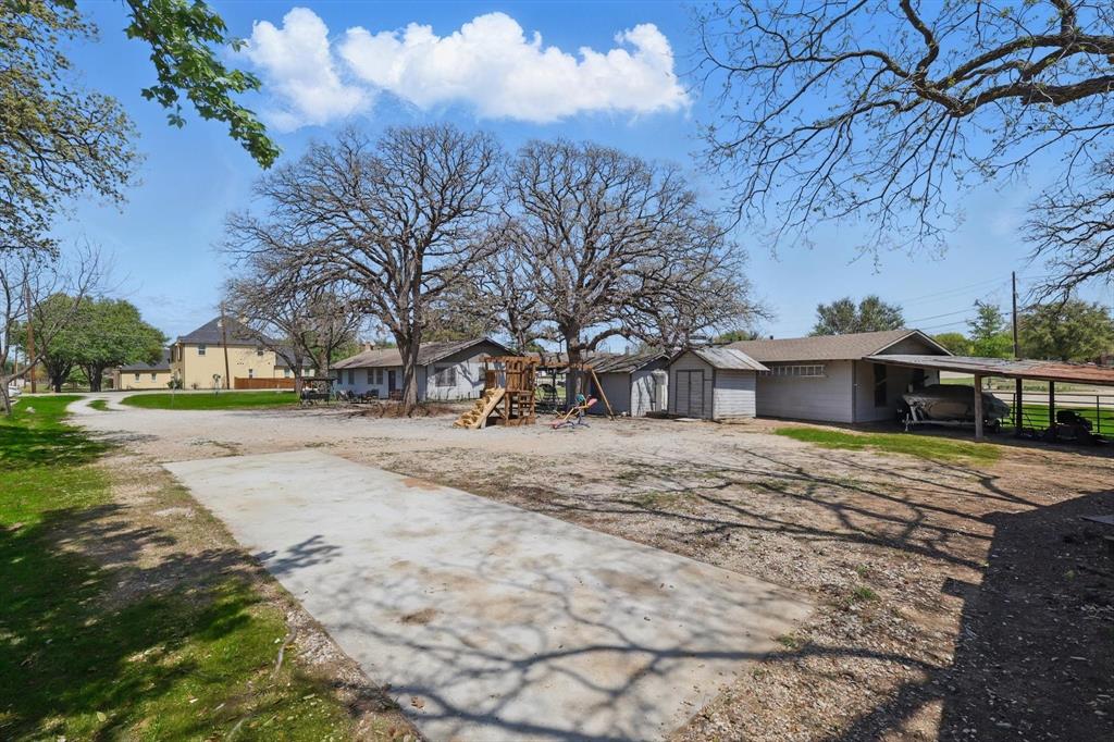 1509 Tinker Road Colleyville, TX 76034 - Photo 11 of 18 a pathway of a house with a yard covered in snow