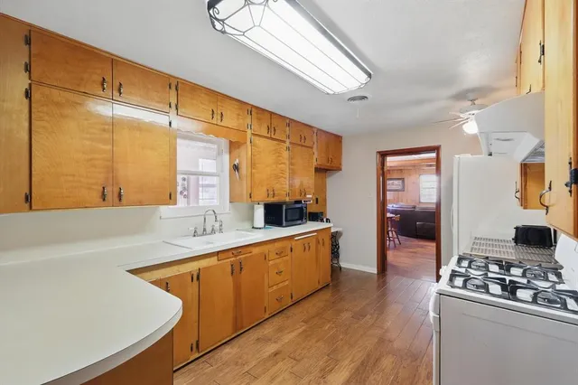 a kitchen with stainless steel appliances a sink stove and cabinets