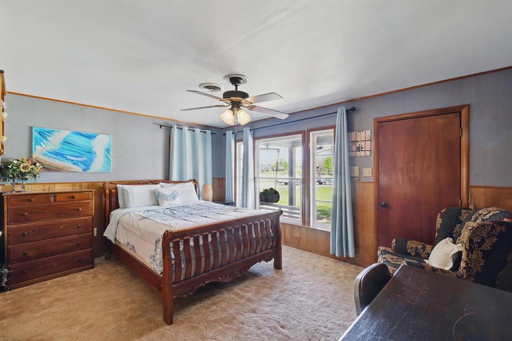 1509 Tinker Road Colleyville, TX 76034 - Photo 16 of 18 a bedroom with a bed and a chandelier