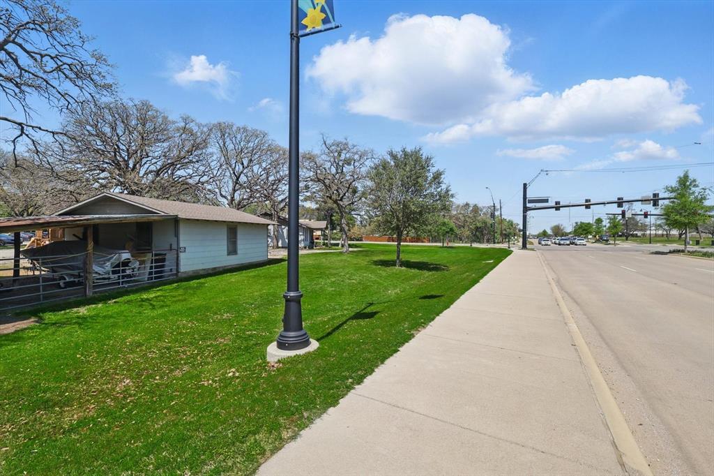 1509 Tinker Road Colleyville, TX 76034 - Photo 9 of 18 a view of a patio with a table and chairs under an umbrella