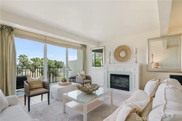 a living room with furniture a window and a fireplace