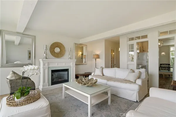 a living room with furniture a clock and a fireplace