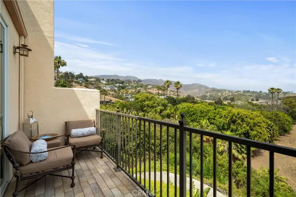 a view of a balcony with couches and wooden floor
