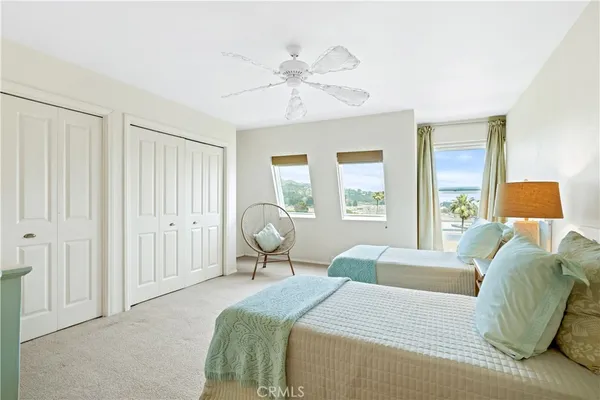 a view of a bedroom with a bed and window