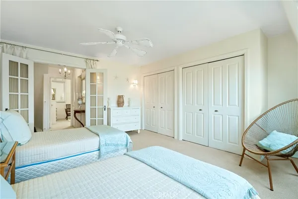 a spacious bedroom with a bed a table and chair