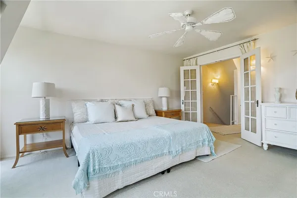 a spacious bedroom with a bed and a chandelier