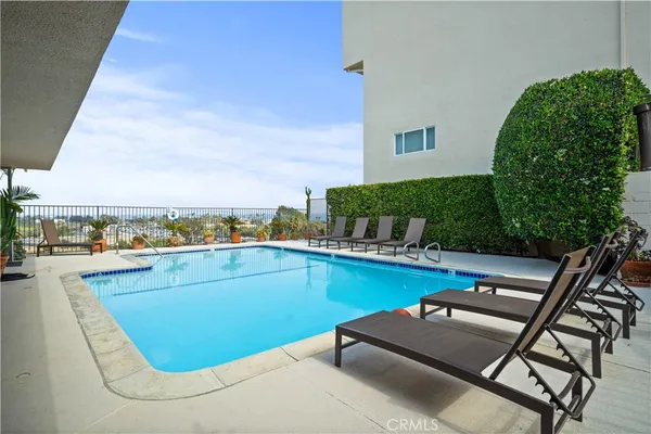 a view of a swimming pool with a lounge chair