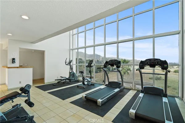 a room with gym equipment and a large window