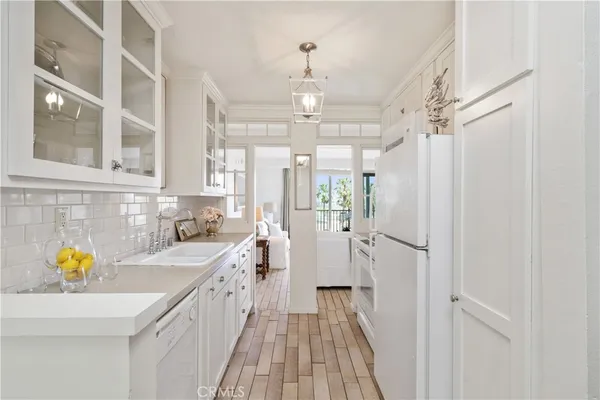 a bathroom with a sink a faucet a window and stainless steel appliances