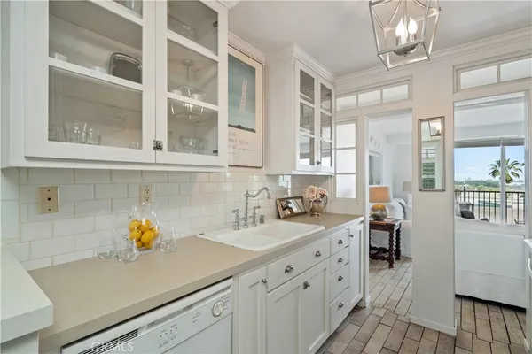 a kitchen with stainless steel appliances sink cabinets and wooden floor
