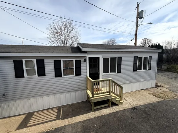 a view of a house with a wooden fence