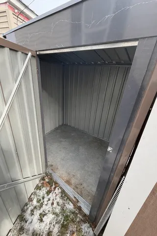 a view of a house with a wooden fence