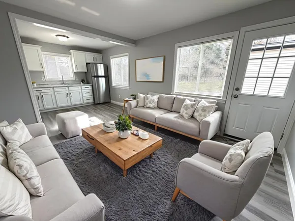 a living room with furniture and a large window