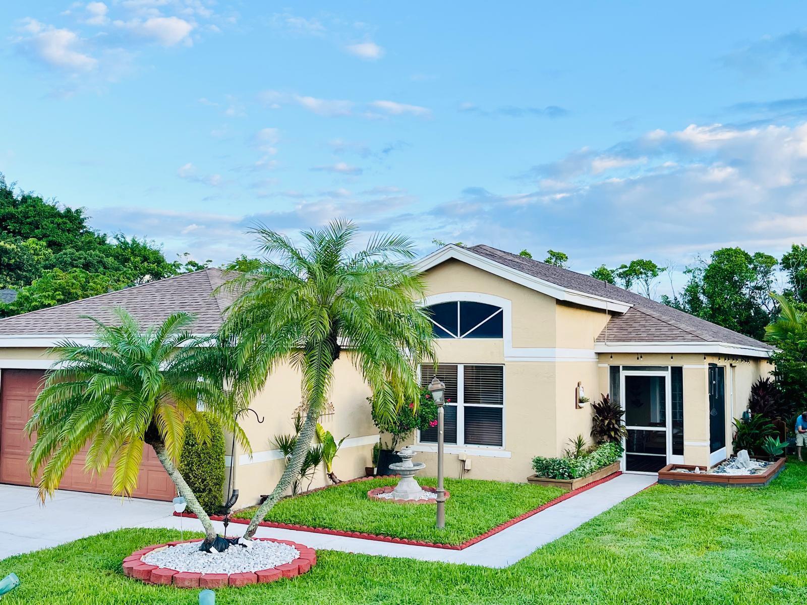 a front view of house with yard and green space