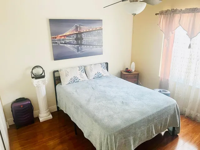 a bedroom with a bed and a mirror