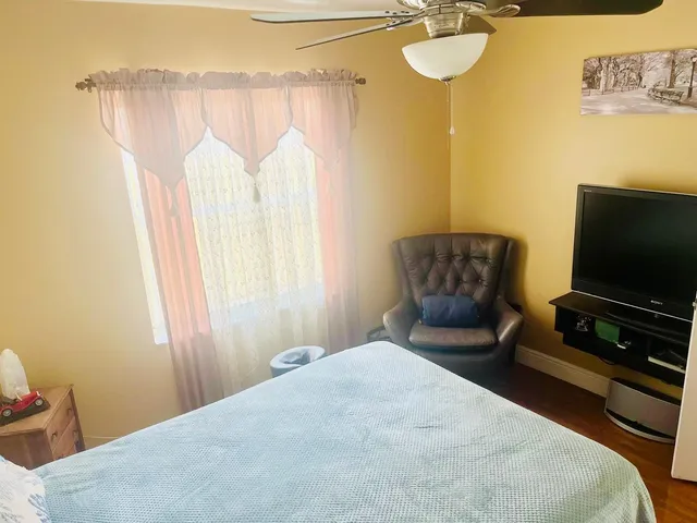a bedroom with a bed and flat screen tv