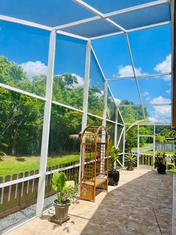 a view of a deck with wooden floor and fence