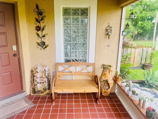 a bath room with a bathtub and potted plant