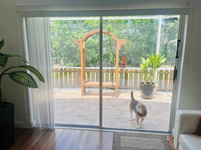 a floor to ceiling window with wooden floor