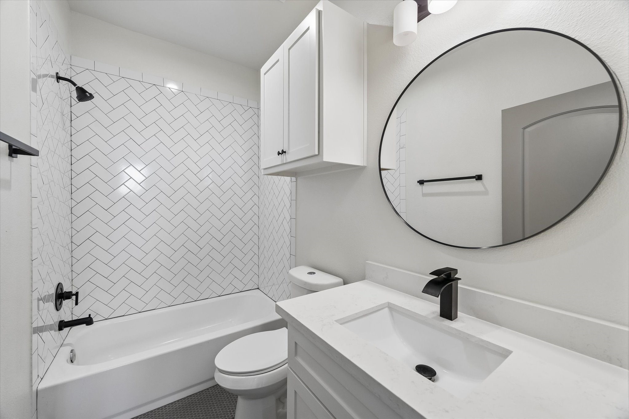 2749 Redrock Street, Unit B Houston, TX 77088 - Photo 19 of 24 Conveniently accessible from the second & third bedrooms is the home's second full bath with painted Shaker-style cabinets, quartz counter top, wall mounted mirror & lighting above. As well as a tile surrounded combination tub/shower.