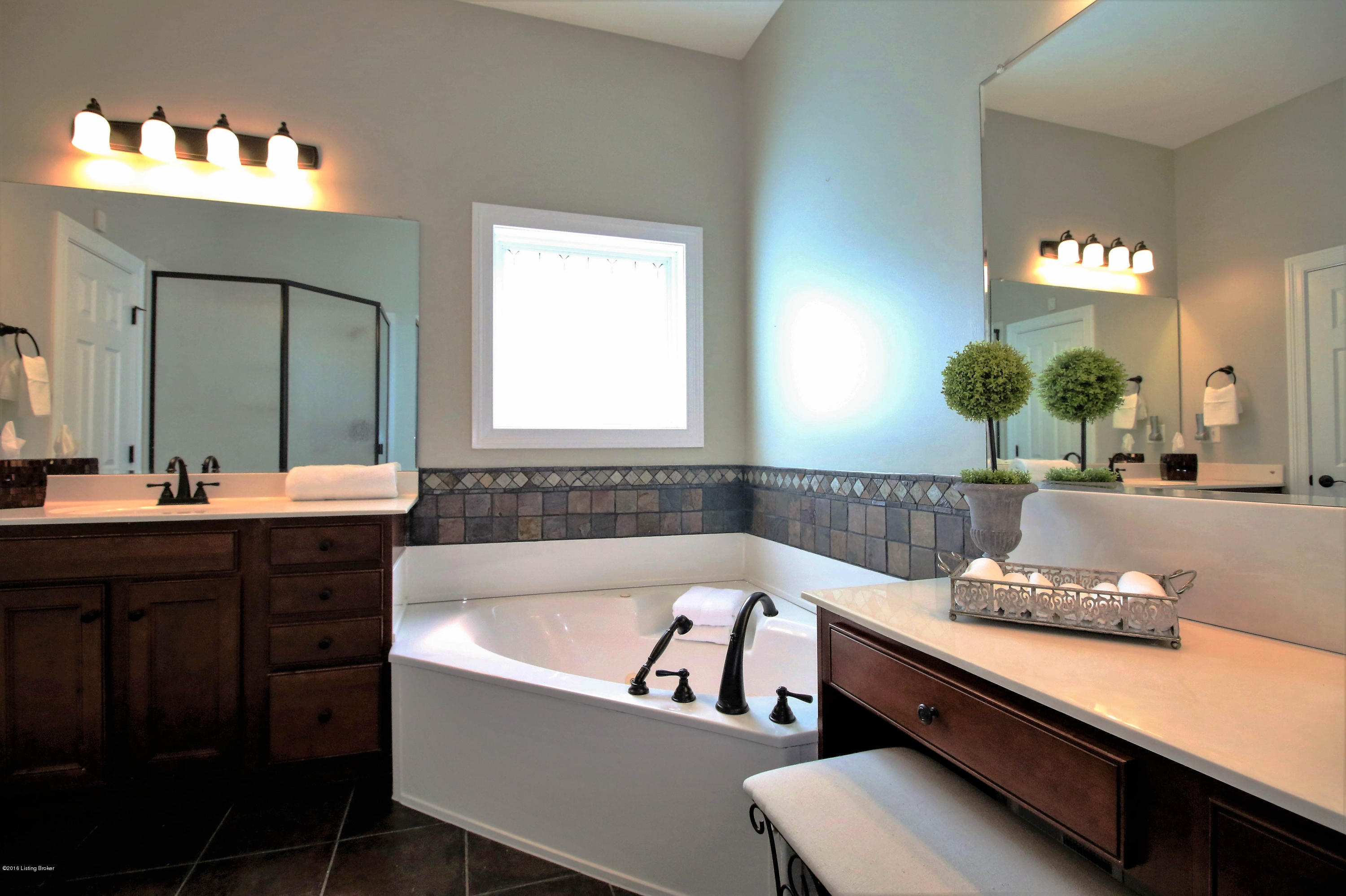 2904 Doe Ridge Court Prospect, KY 40059 - Photo 52 of 86 The flooring is a bold hue which complements the light walls and tops. The custom tile work continues around the corner jetted soaking tub, complete with detachable sprayer.