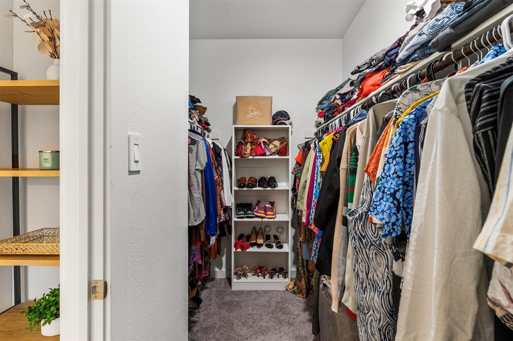 2407 Neff Lane Forney, TX 75126 - Photo 11 of 22 a view of walk in closet with clothes and shoes