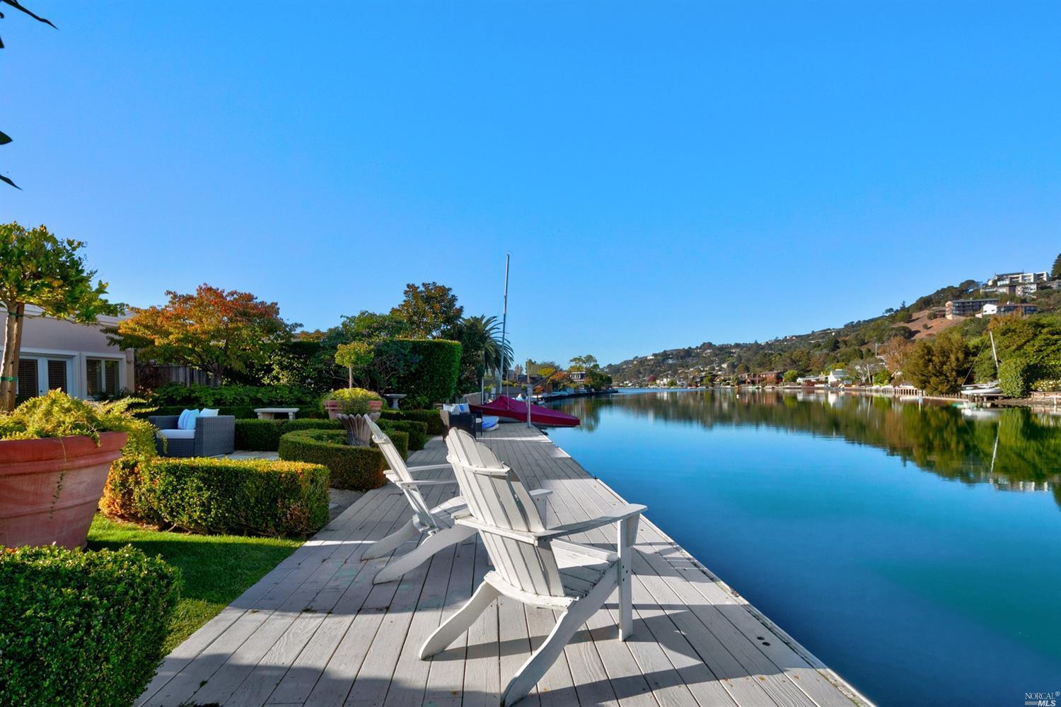 a view of a lake with couches in the patio