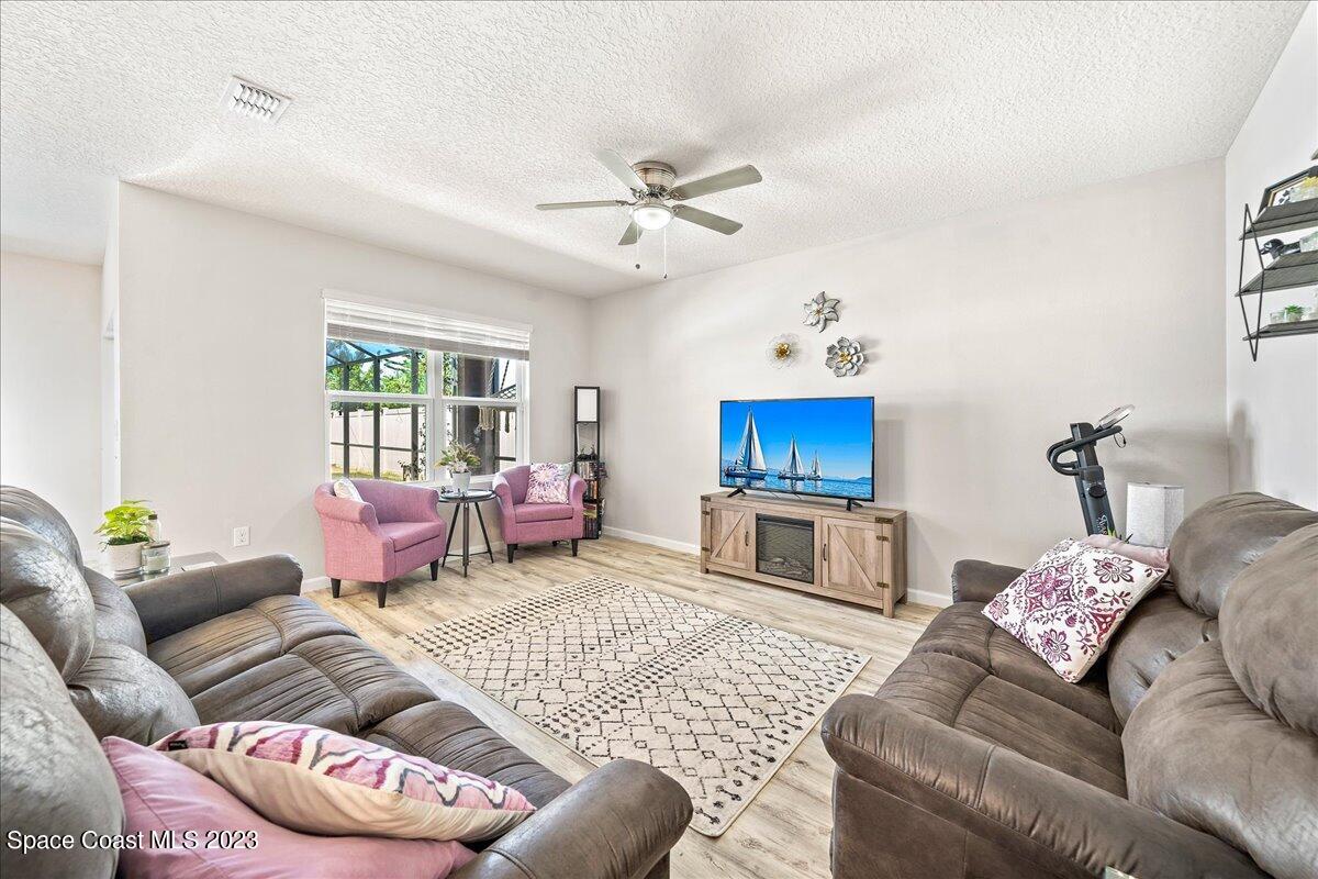4480 Pagosa Springs Circle Melbourne, FL 32901 - Photo 13 of 41 a living room with furniture and a fireplace