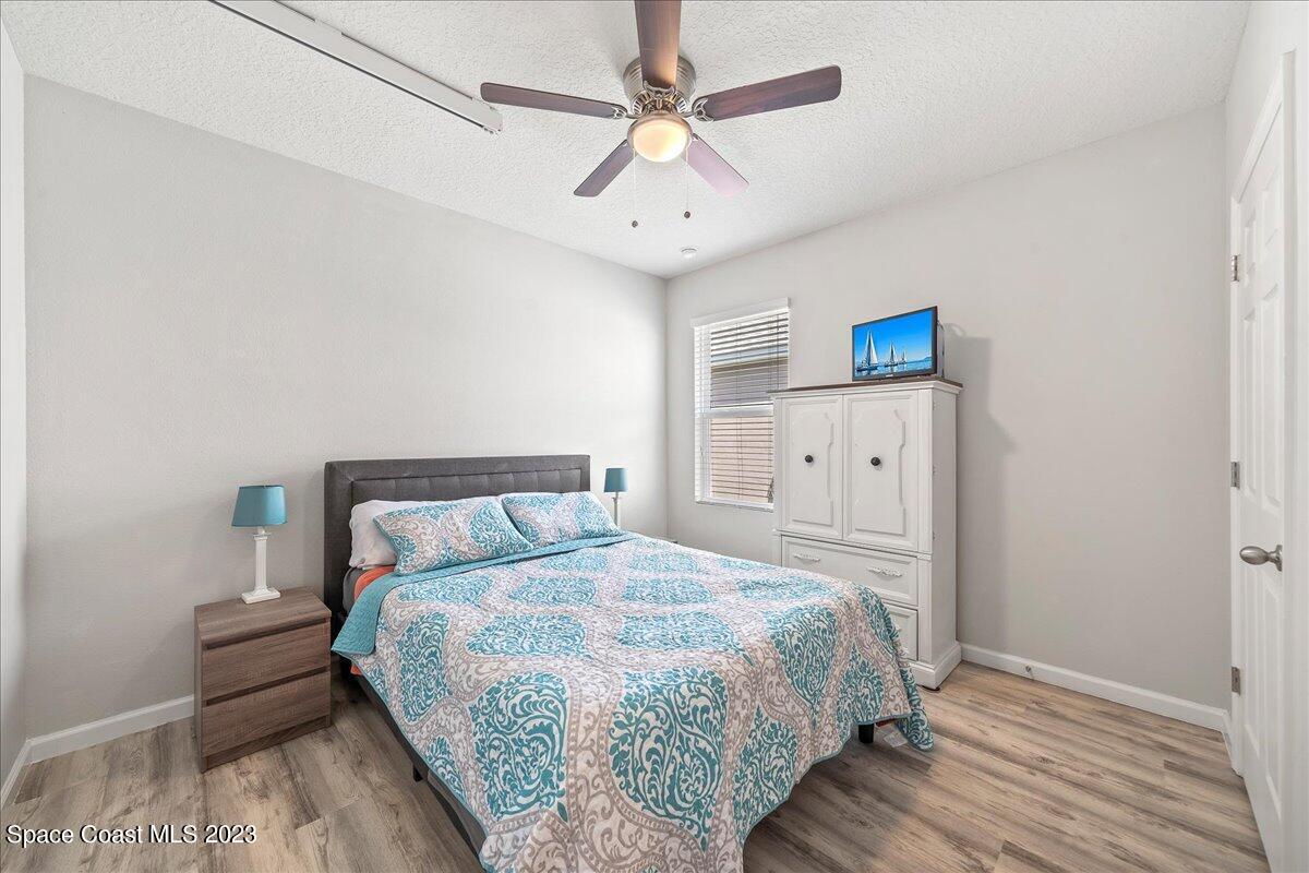 4480 Pagosa Springs Circle Melbourne, FL 32901 - Photo 15 of 41 a bedroom with a bed and a ceiling fan