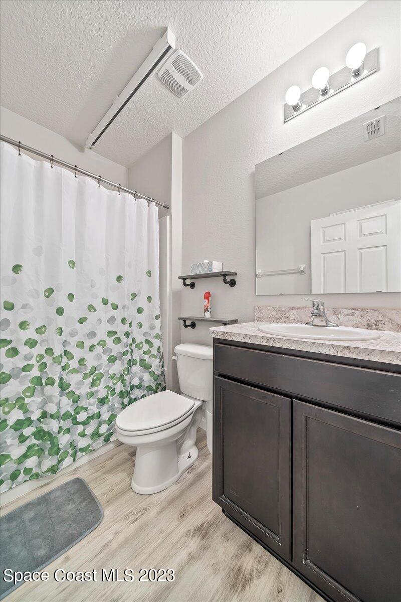 4480 Pagosa Springs Circle Melbourne, FL 32901 - Photo 16 of 41 a bathroom with a granite countertop sink toilet mirror vanity and shower