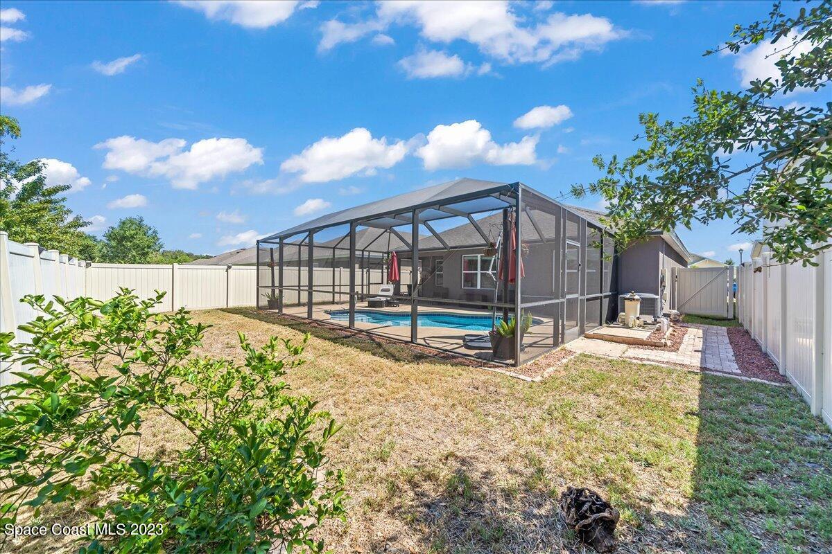 4480 Pagosa Springs Circle Melbourne, FL 32901 - Photo 28 of 41 a view of a backyard with brick wall and potted plants