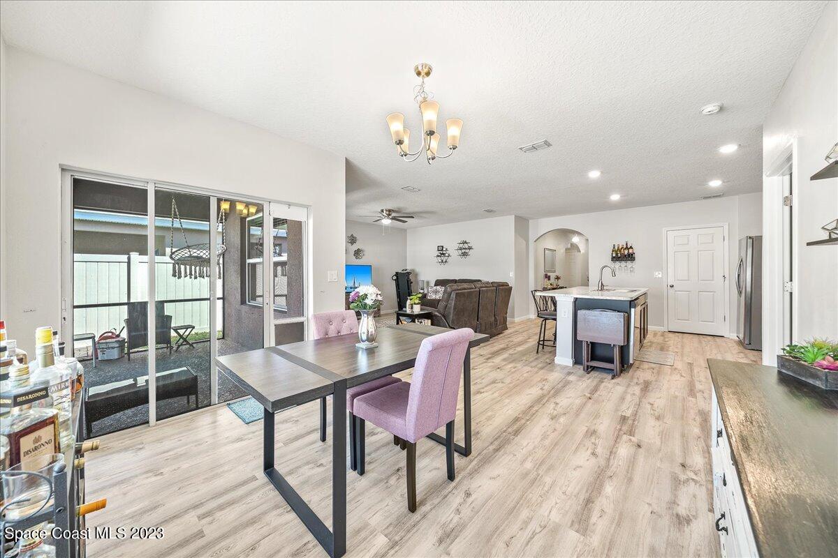 4480 Pagosa Springs Circle Melbourne, FL 32901 - Photo 10 of 41 a living room with furniture a dining table and a potted plant