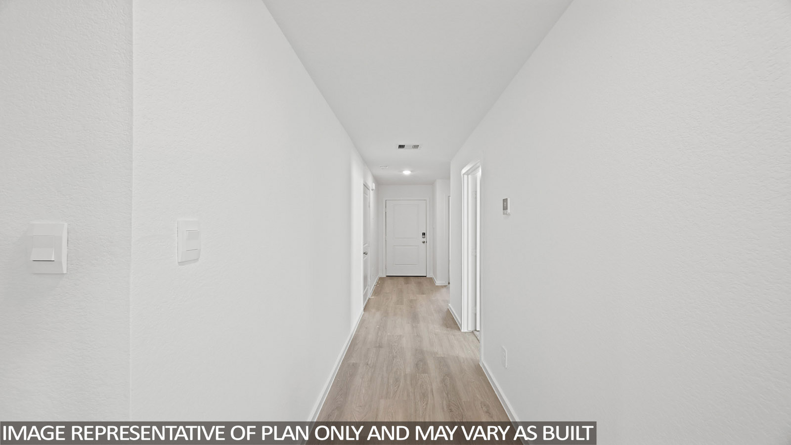 165 Baby Calf Roping Road Jarrell, TX 76537 - Photo 2 of 24 A well-lit corridor with light wood-style flooring and several white panel doors.
