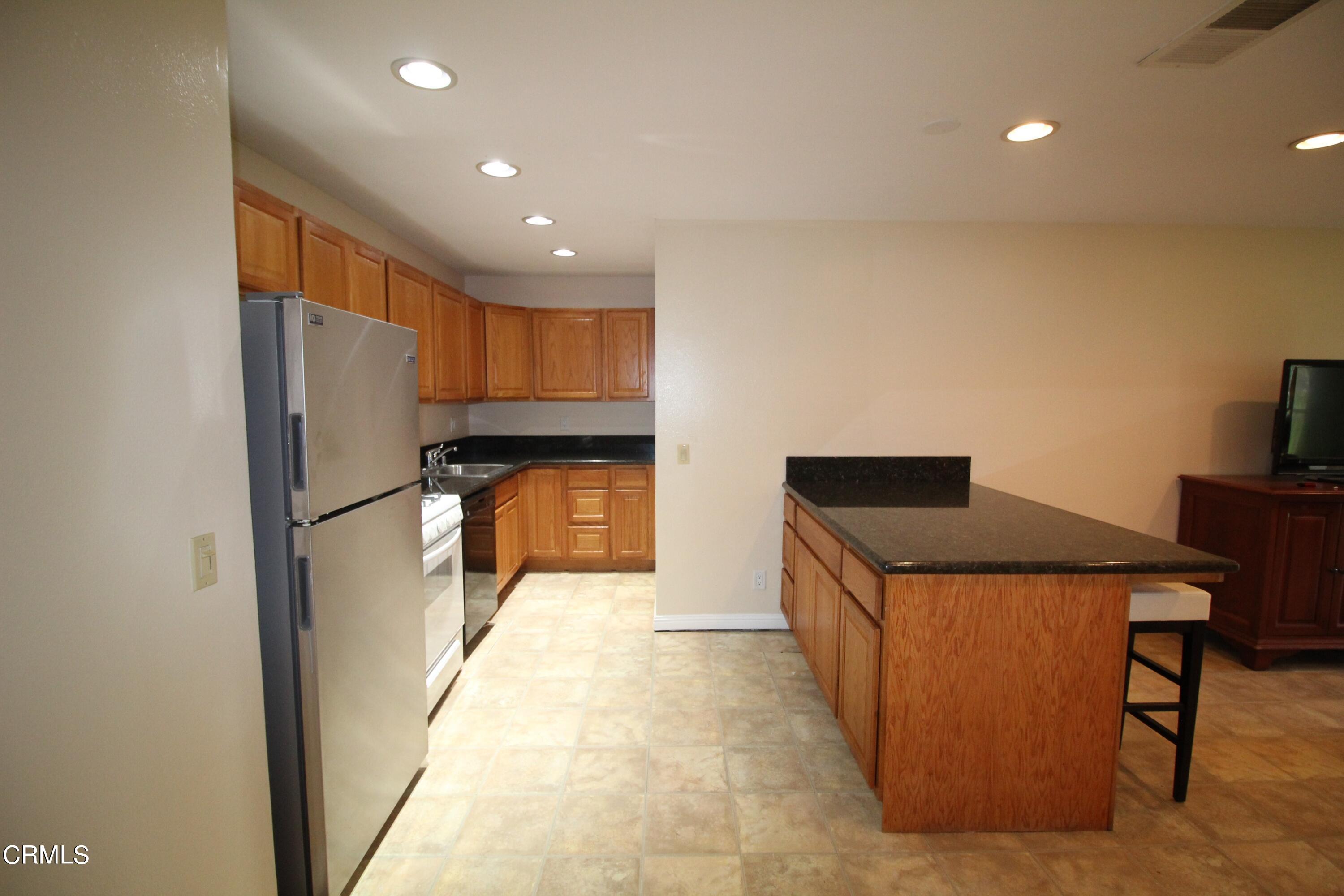 701 Reef Circle Port Hueneme, CA 93041 - Photo 4 of 17 a kitchen with stainless steel appliances granite countertop a refrigerator and a stove