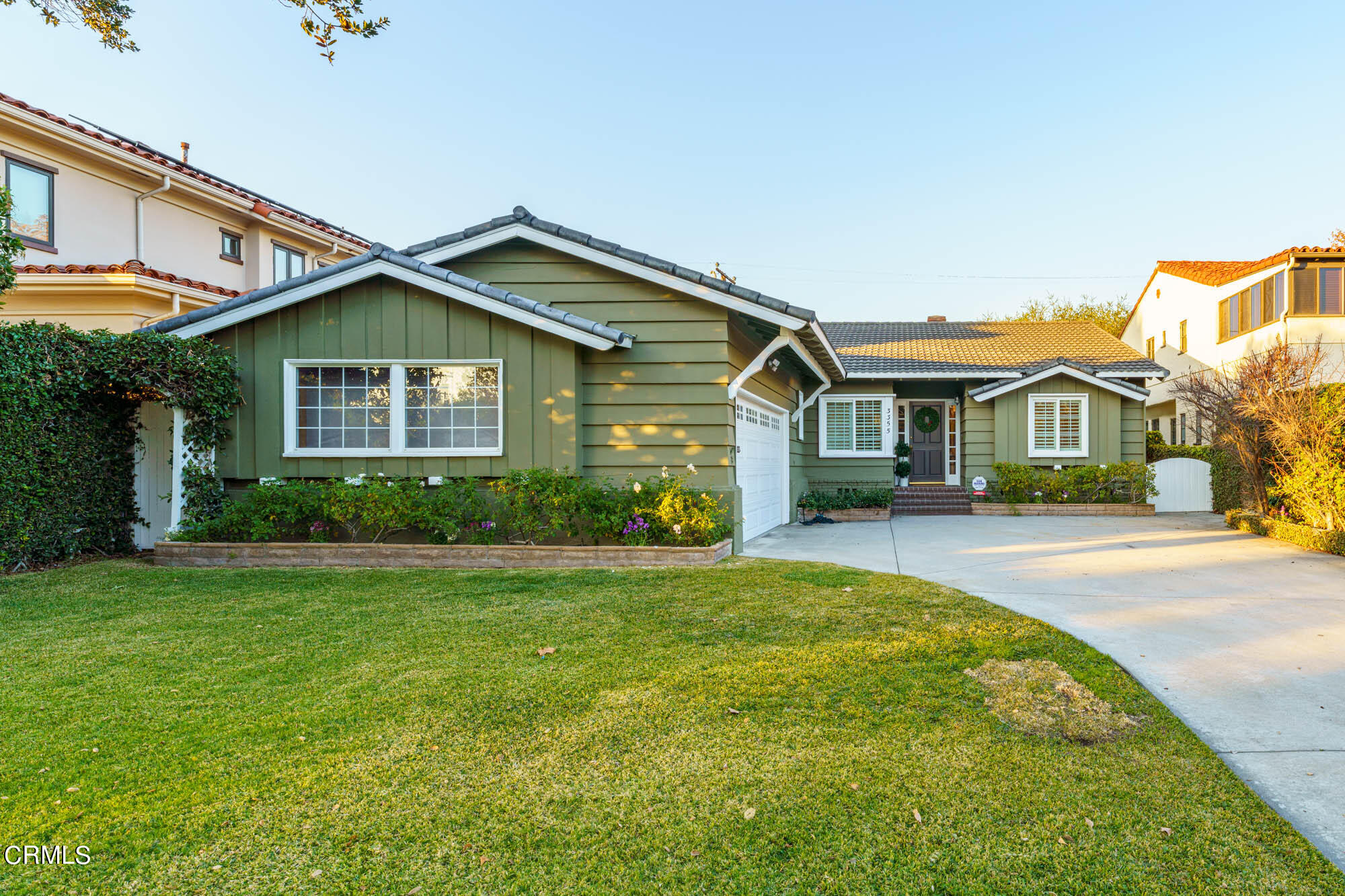 a front view of a house with a garden