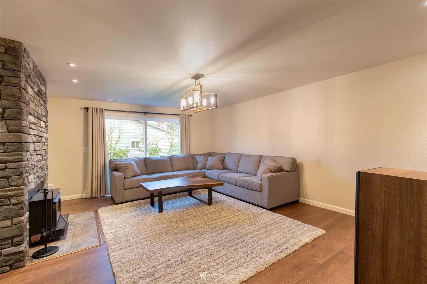 21523 4th Avenue West, Unit B34 Bothell, WA 98021 - Photo 8 of 13 a living room with furniture and a chandelier