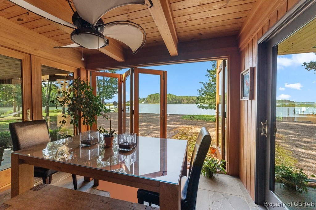 1106 Monarch Shores Road Kilmarnock, VA 22482 - Photo 20 of 44 Sunroom featuring beamed ceiling, a water view, ceiling fan, and a wealth of natural light