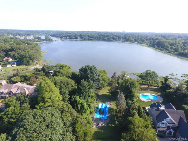 an aerial view of house with yard and lake view