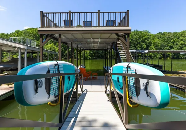 a view of a balcony with chairs and wooden floor