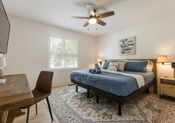 a bed room with a bed and a chair