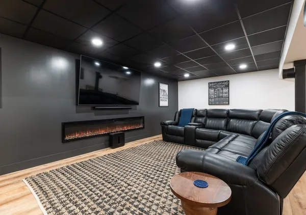 a living room with furniture and a wooden floor