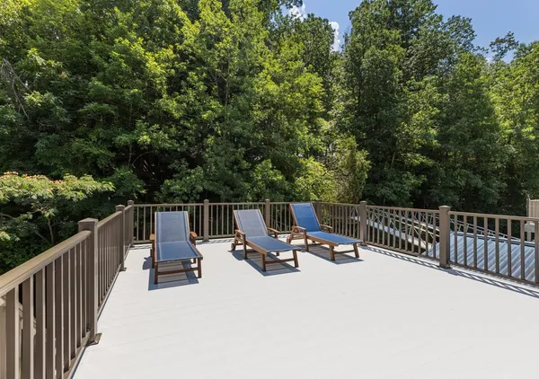 a view of a house with pool and deck