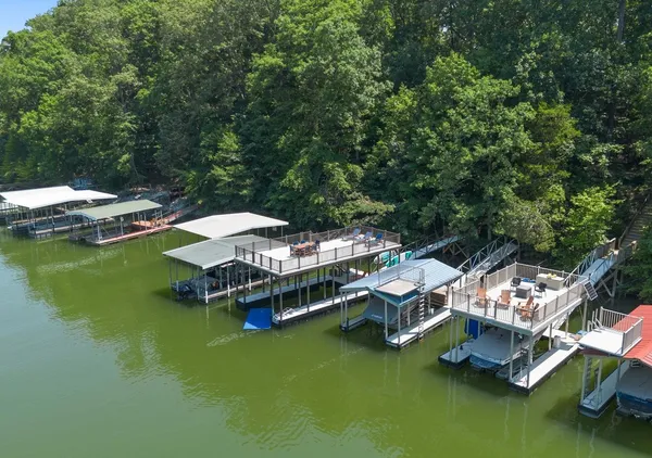 a view of a lake with lawn chairs