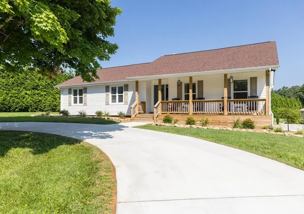 a view of a house with swimming pool and a yard