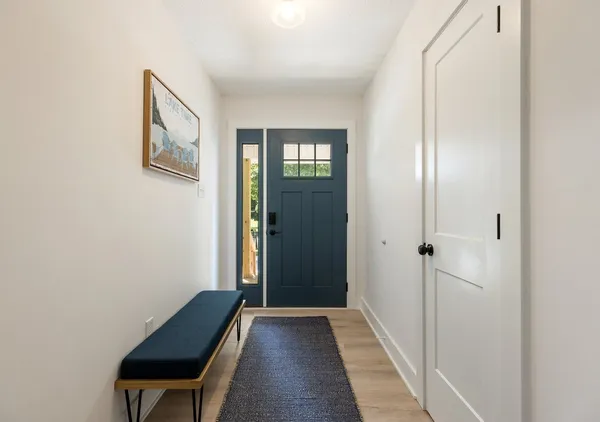 a view of a hallway with entryway door
