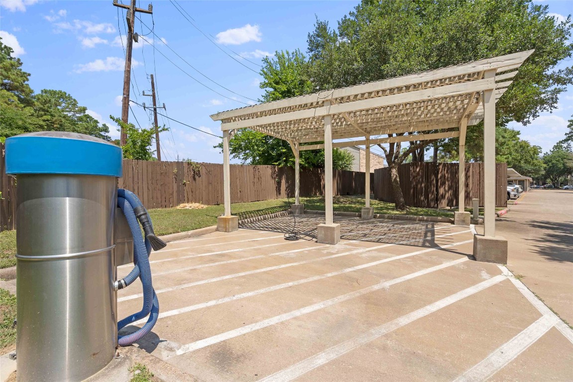 2400-1133 Spring Rain Drive Spring, TX 77379 - Photo 22 of 29 a view of a house with floor to ceiling windows and a basket ball poll