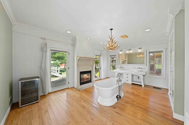 an empty room with wooden floor and a window