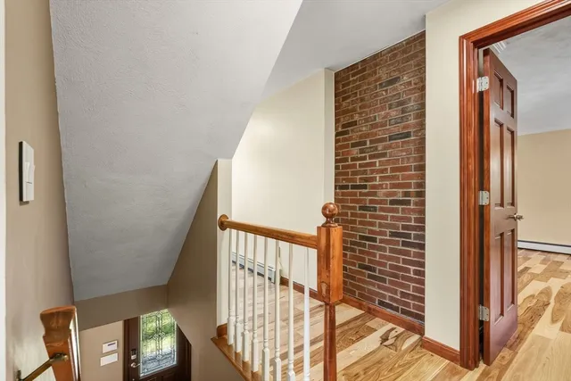 a view of staircase with railing and a window