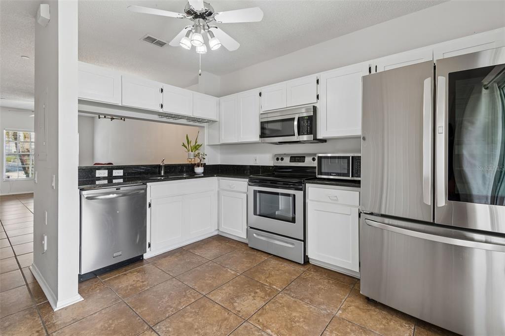 382 Countryside Key Boulevard Oldsmar, FL 34677 - Photo 15 of 58 a kitchen with cabinets stainless steel appliances and a counter top space