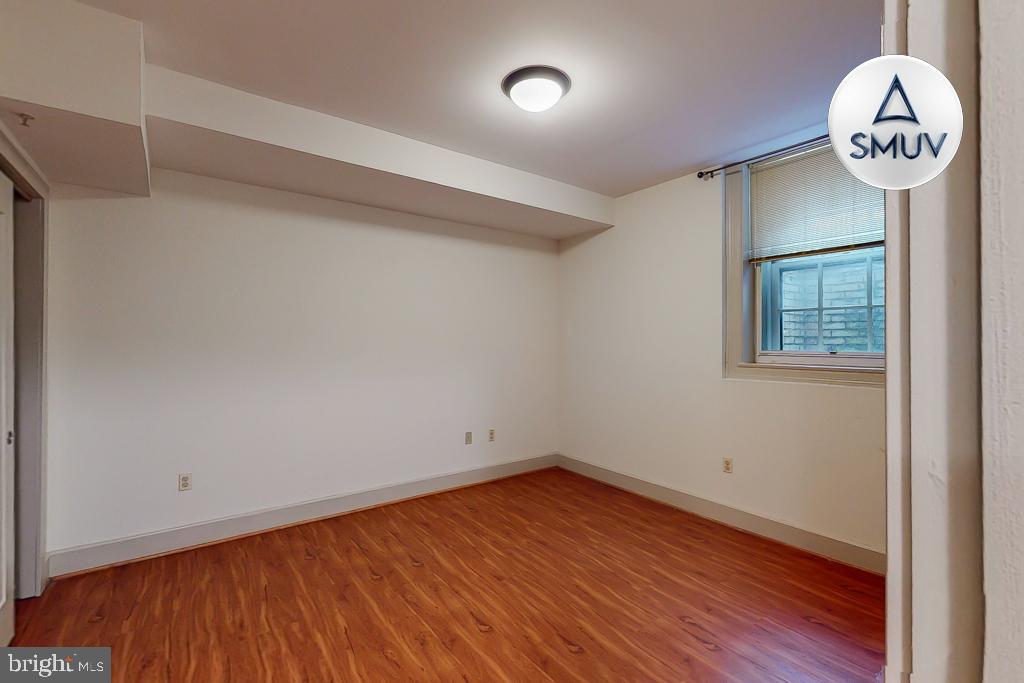 11 East Chase Street, Unit T03 Baltimore, MD 21202 - Photo 10 of 22 a view of a big room with wooden floor and a window